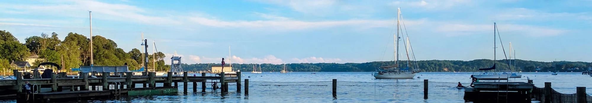 The piers and moored sailboats off the Olde Severna Park beach on a summer evening